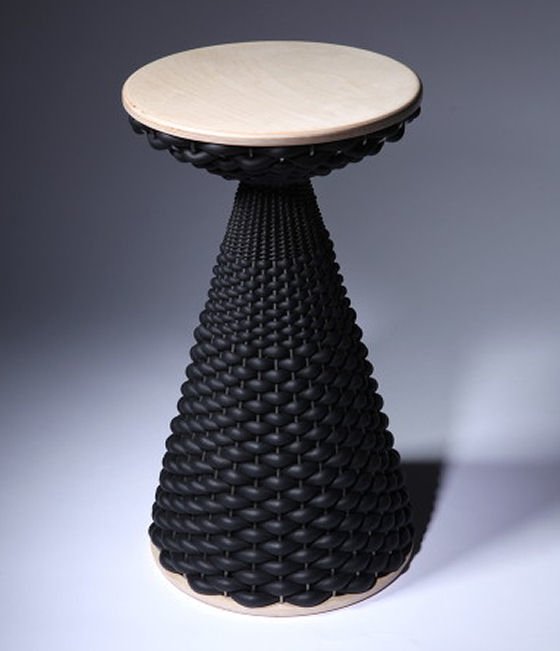 Stool made of woven black sponge cord with wooden seat