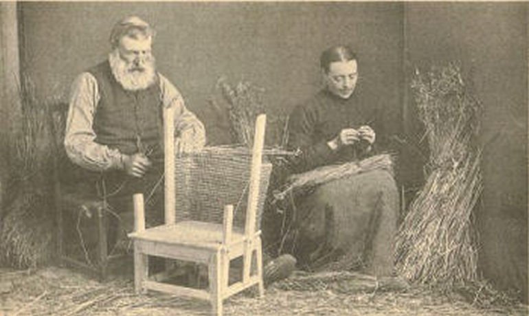 Sepia photograph of couple making straw-backed chairs