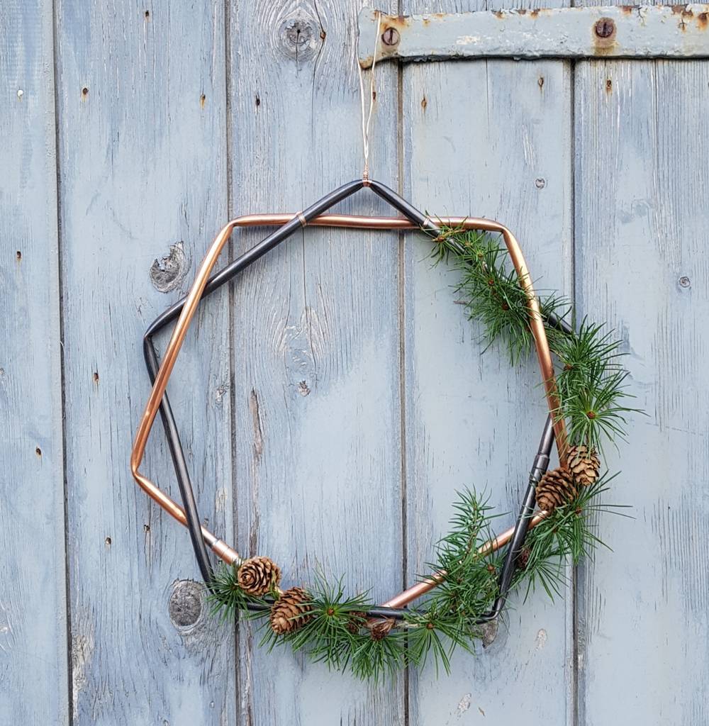Alternative Christmas Wreath made of copper tybe and pine cones and greenery