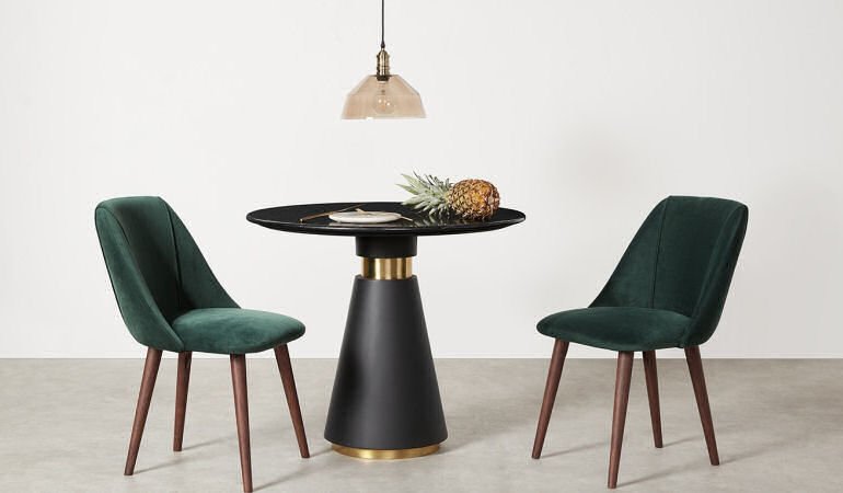 MADE Bimba round dining table for small spaces in black marble and brass