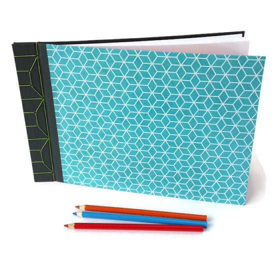 Grey bookcloth and turquoise lokta paper stab bound handmade journal with coloured pencils