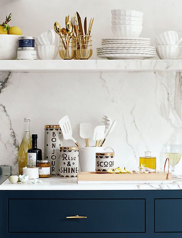 Anthropologie kitchenware in blue contemporary kitchen with margle tops and walls