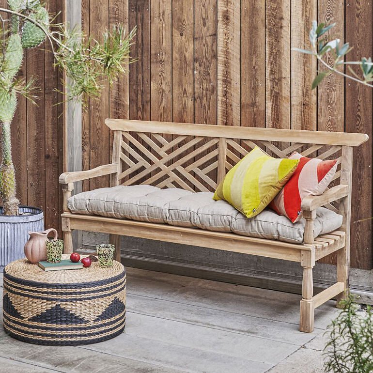 Graham & Green contemporary garden bench with long linen padded cushion and rattan side table