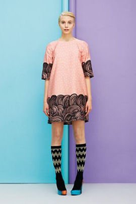Coral and black Marimekko dress against turquoise/lilac background