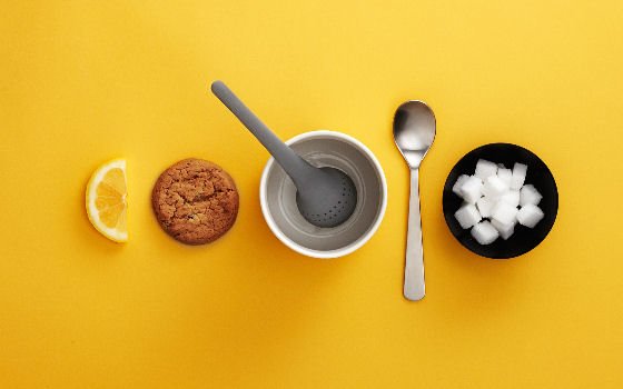 Grey Normann Copenhagen Tea Egg in white cup on yellow background