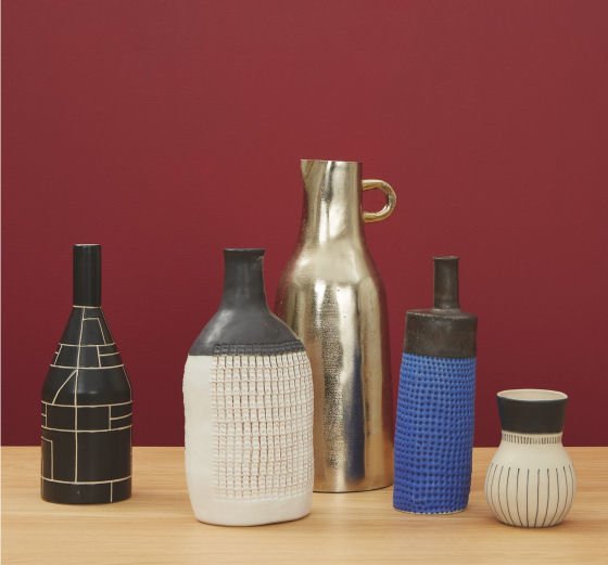 Contemporary bottle vases from Habitat against red background