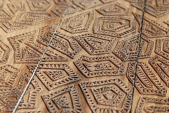 Fine geometric shapes etched into reclaimed wood