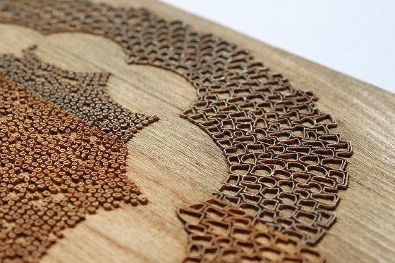 Lacy decorative design laser cut into natural wood surface