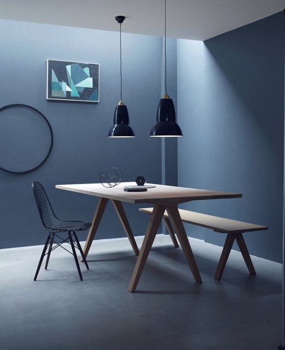 2  Anlepoise Brass Collection Maxi Pendant Lamps hanging over wooden dining table against dark blue walls