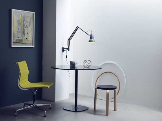 Anglepoise Wall Mounted Brall Collection Lamp over pedestal table, with yellow swivel chair and wooden stool