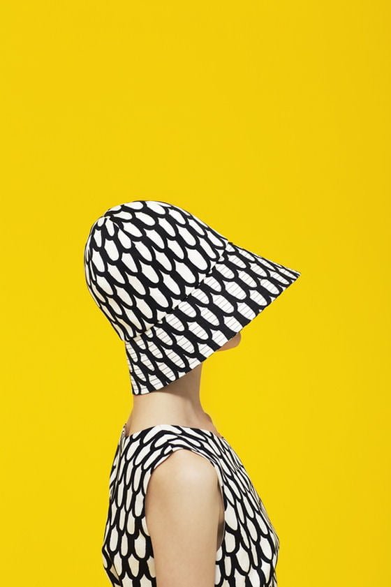 Black and white Marimekko hat and dress against sunshine yellow background
