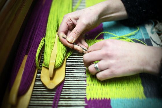 Angie Parker, weaving at her loom Angie Parker, weaving at her loom