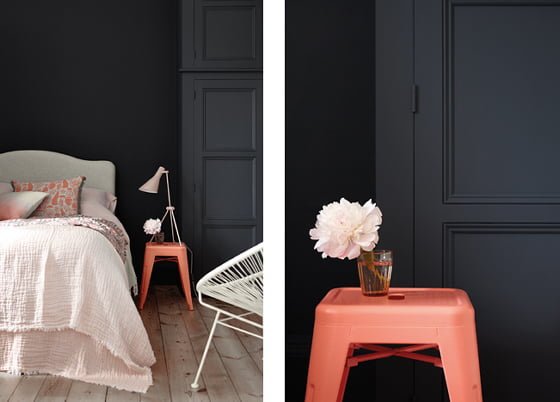dark blue bedroom wall in Basalt by Little Greene with coral stool