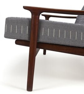 close up of grey and white fabric on wooden mid century sofa