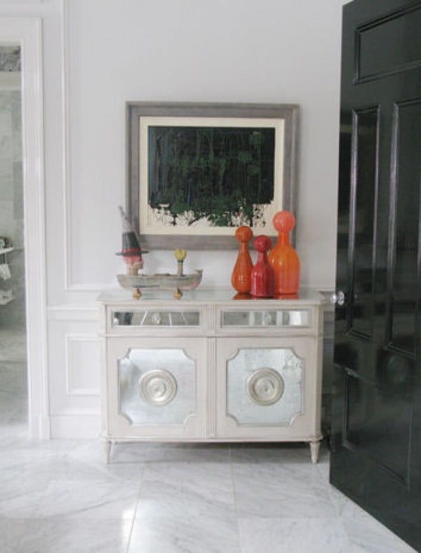 Elizabeth Lyons orange glass bottles in room setting