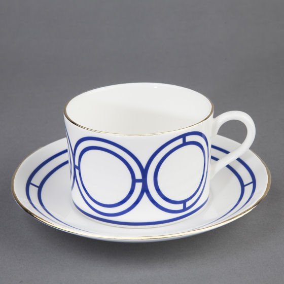 Bone china cup and saucer in white with blue graphic design