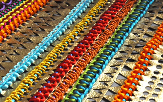 Turquoise, yellow, red and orange braided interiors fabric with metallic leather