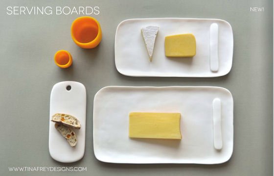 White resin serving boards with cheese and orange resin cups