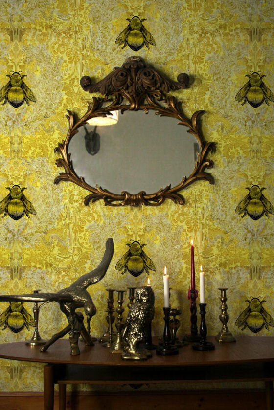 Imperial Apiary Yellow Timorous Beasties Imperial Apiary wallpaper in yellow with ornate mirror and ornaments