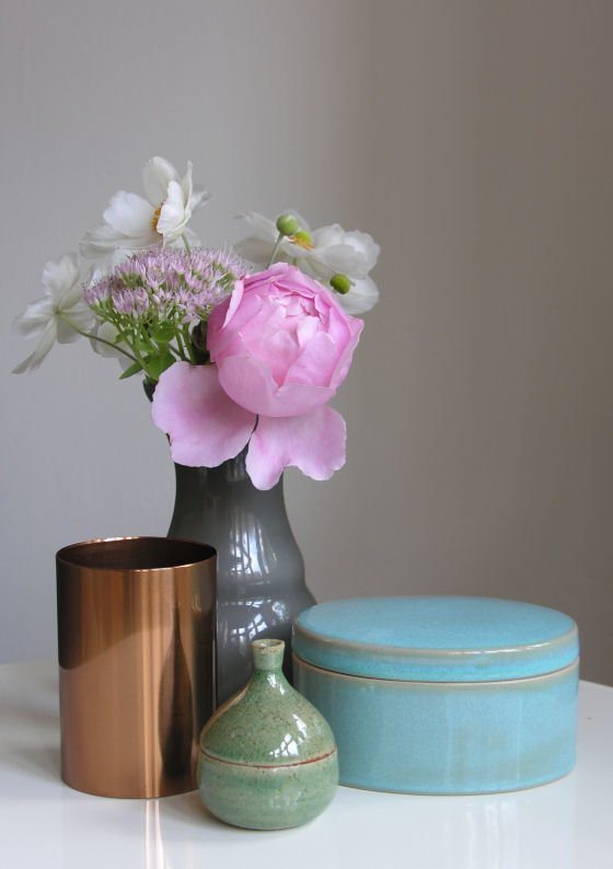 Grey vase with pink rose and ceramic boxes