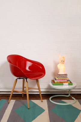 Red Armrest Chair Red plastic bucket armchair with wooden legs