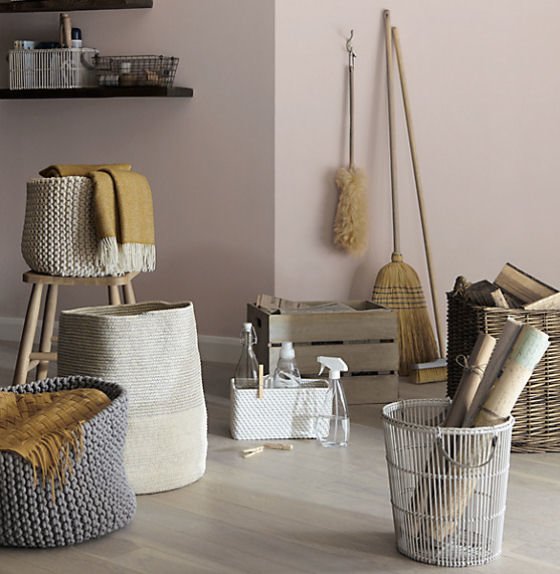 Croft Collection knitted storage baskets and white rattan baskets with other cleaning and utility items