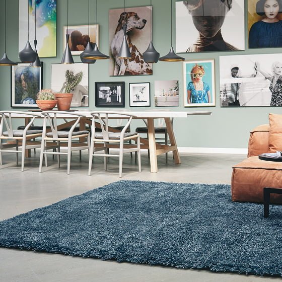 Blue Stonewash Rug on floor with dining table and chairs and pictures on wall