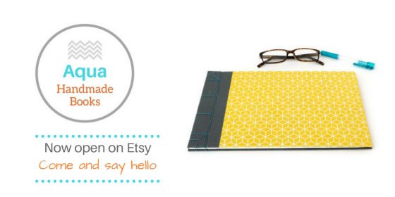 Aqua Handmade Books Etsy logo and image of grey and yellow handmade journals