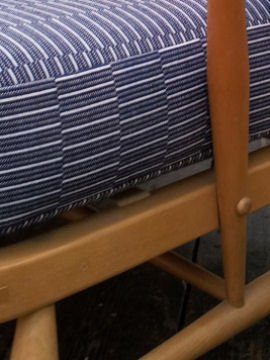 Detail of upholstered mid century sofa in blue and white fabric