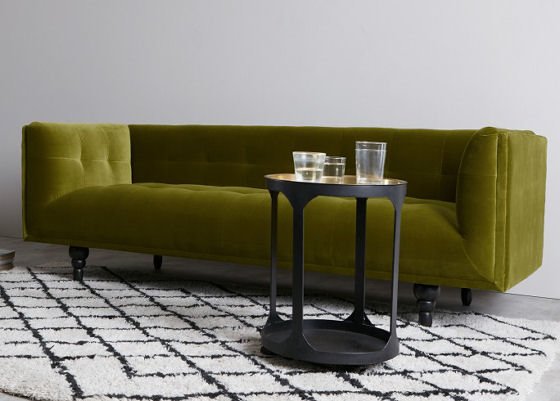 contemporary velvet sofa in olive green cotton velvet with black side table
