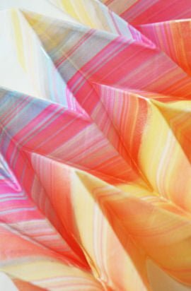 Stripes of blue, yellow pink and orange on folded, pleated textile