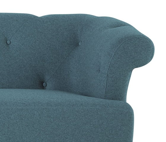 Detail of blue contemporary Chesterfield sofa showing buttoned back