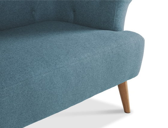 Detail of contemporary Chesterfield sofa legs and seat