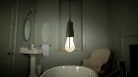 Plumen 002 light bulb with black drop cap energy saving Plumen 002 light bulb with black drop cap in bathroom setting