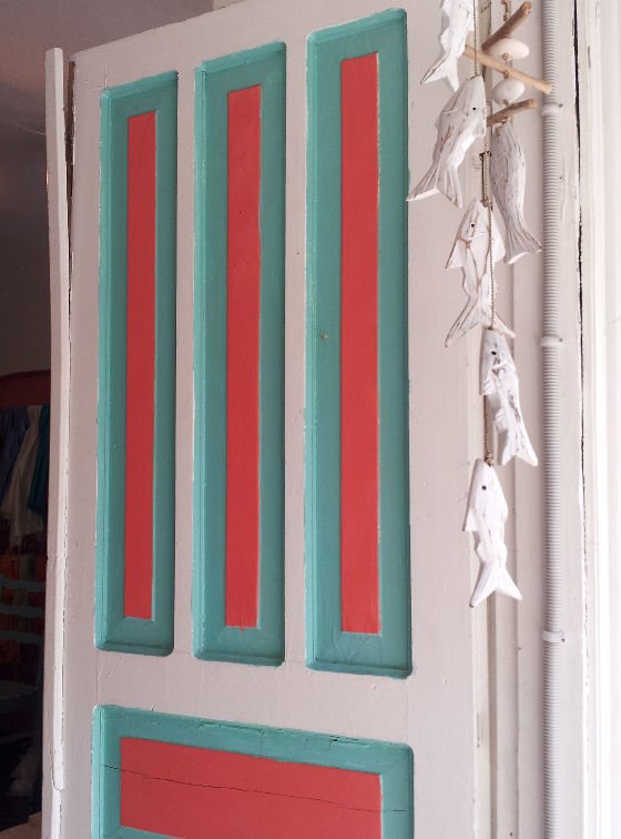 red and turquoise door with white fish mobile in Kas Turkey
