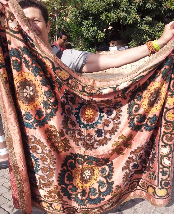 Lady holidng up embroidered vintage textile