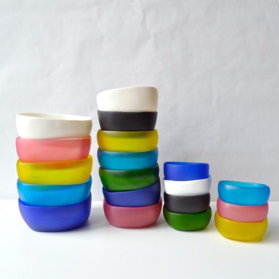 Colourful selection of stacked resin bowls by Tina Frey
