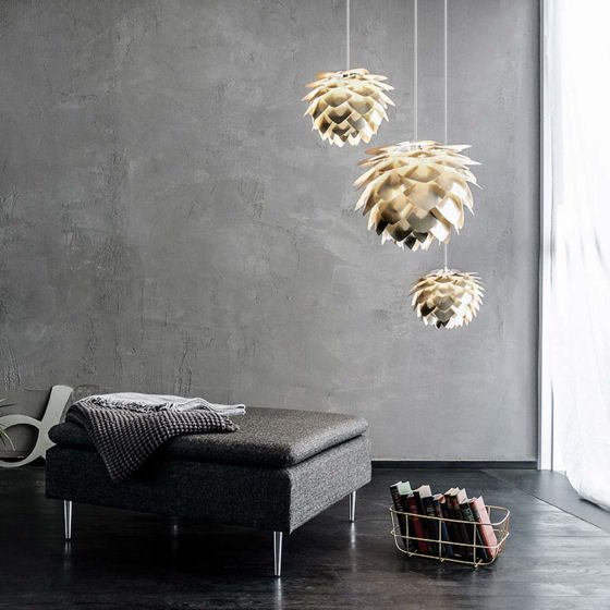Cluster of small and large Silvia light shades in brass with grey wall in contemporary living room